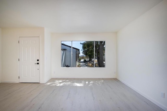 spare room with light wood-type flooring