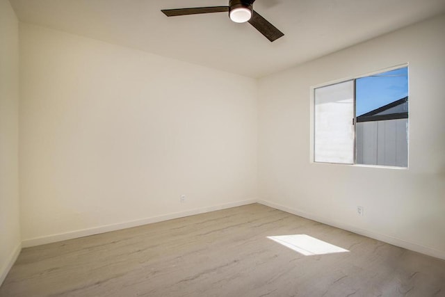 spare room featuring light hardwood / wood-style flooring and ceiling fan