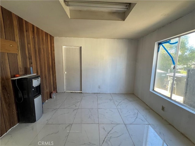 spare room featuring wood walls