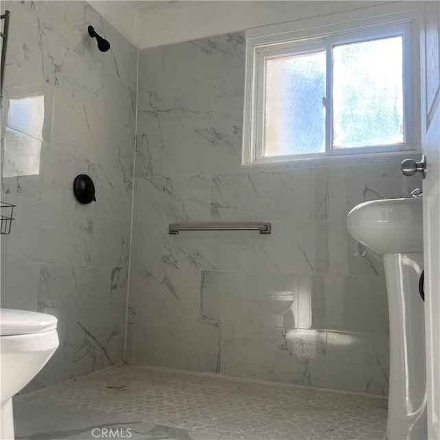 bathroom with tiled shower