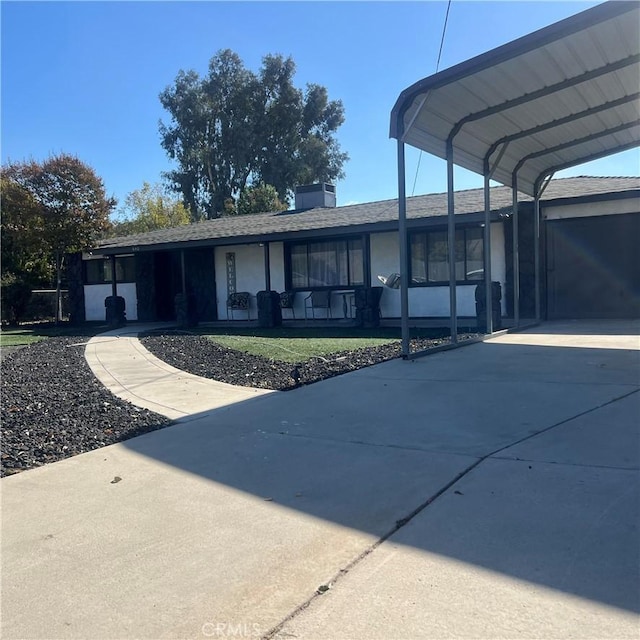 exterior space with a front lawn and a carport