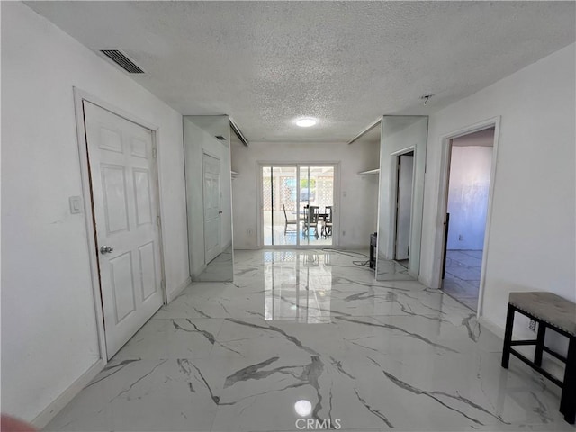 hallway featuring a textured ceiling