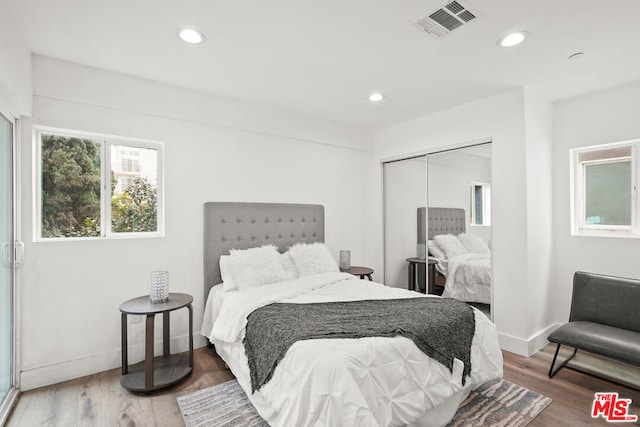 bedroom with hardwood / wood-style floors and a closet