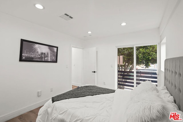 bedroom featuring access to outside and hardwood / wood-style flooring