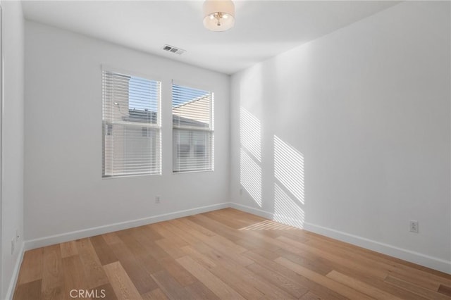 spare room with light hardwood / wood-style flooring