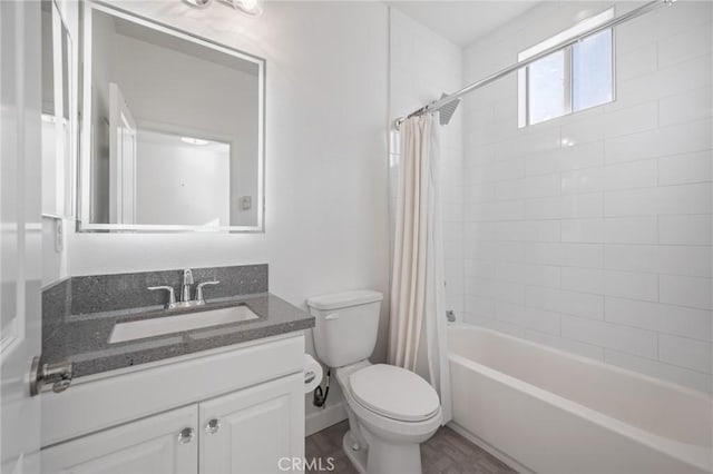 full bathroom featuring toilet, shower / bathtub combination with curtain, hardwood / wood-style floors, and vanity