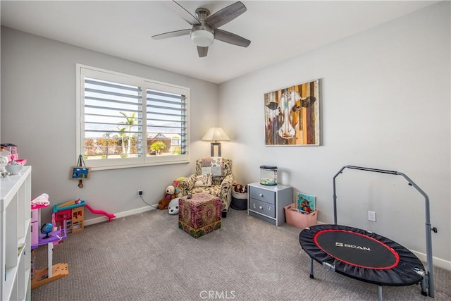 playroom with ceiling fan and light carpet