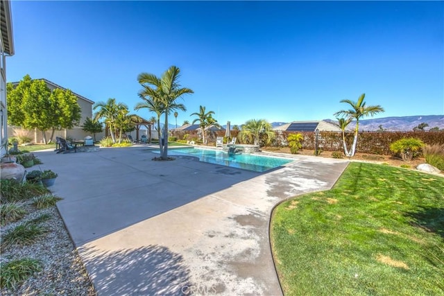 view of swimming pool with a patio area and a yard