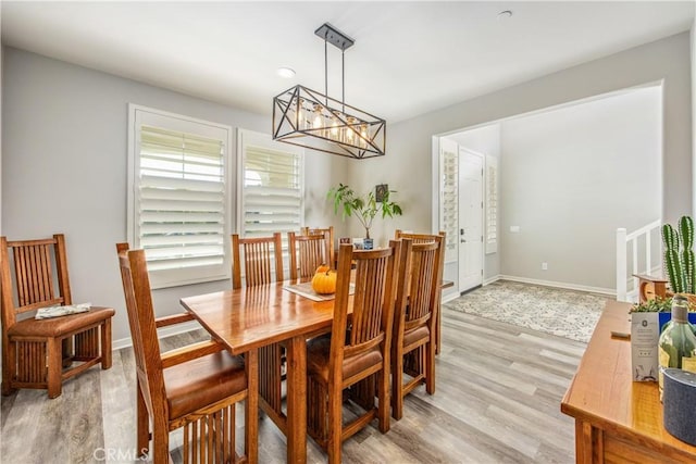 dining area featuring a chandelier and light hardwood / wood-style flooring