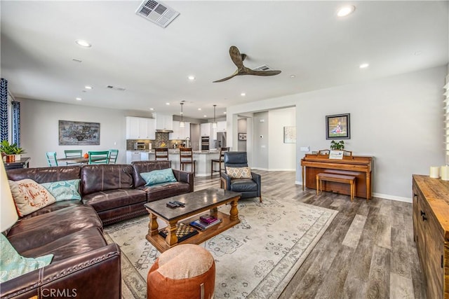 living room with hardwood / wood-style flooring and ceiling fan