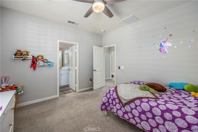 bedroom with ceiling fan, ensuite bathroom, and light carpet