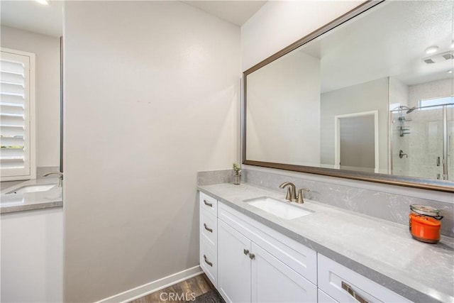 bathroom with vanity, hardwood / wood-style flooring, and walk in shower