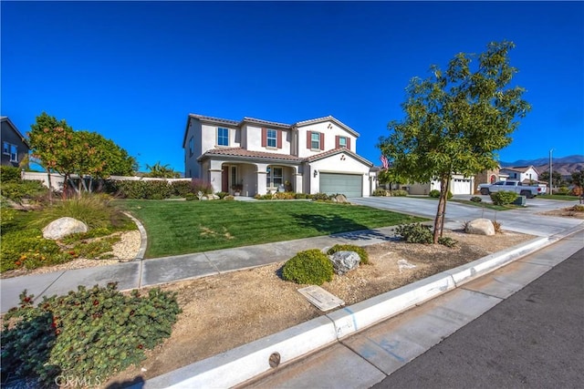 mediterranean / spanish-style home featuring a front yard and a garage