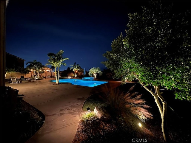 pool at night with a patio