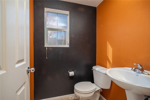 bathroom featuring sink and toilet