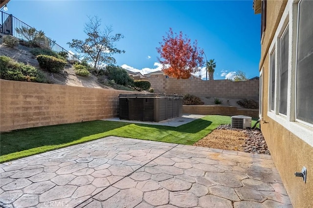 view of patio featuring cooling unit and a hot tub