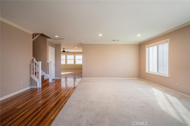 empty room with hardwood / wood-style flooring, ceiling fan, and ornamental molding