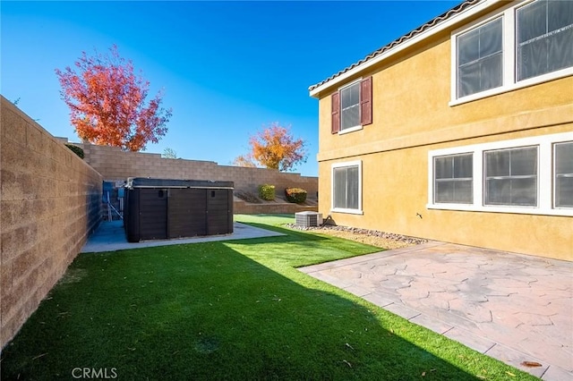 view of yard with central AC unit and a patio area