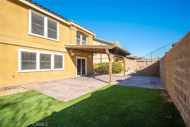 back of house featuring a patio and a lawn