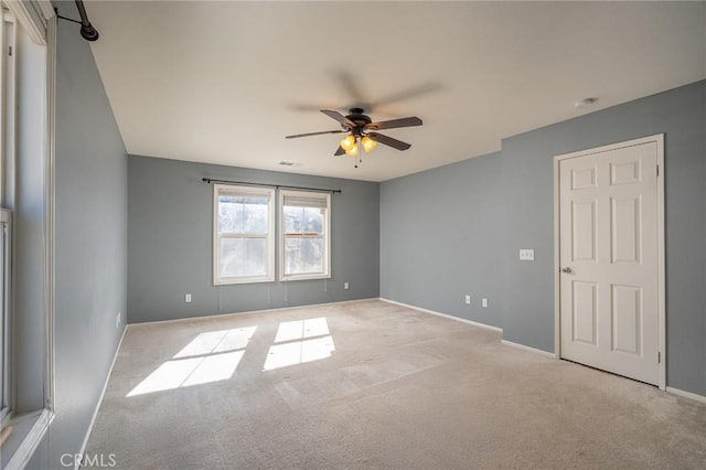 unfurnished room featuring light colored carpet and ceiling fan