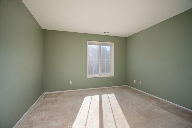 empty room featuring light colored carpet