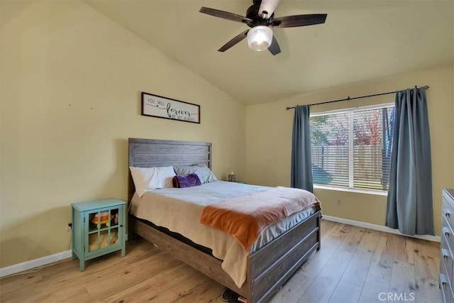 bedroom featuring ceiling fan, vaulted ceiling, and light wood-type flooring