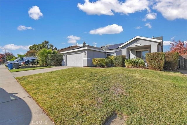 ranch-style home featuring a front yard, solar panels, and a garage