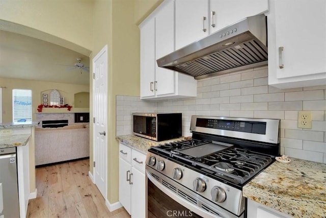 kitchen with white cabinets, light hardwood / wood-style floors, and stainless steel appliances