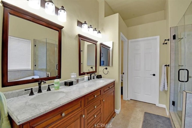 bathroom with tile patterned floors, vanity, and shower with separate bathtub