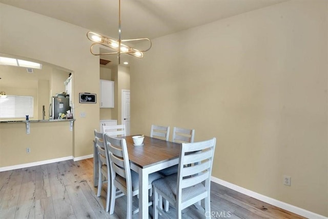 dining room featuring a notable chandelier and wood-type flooring