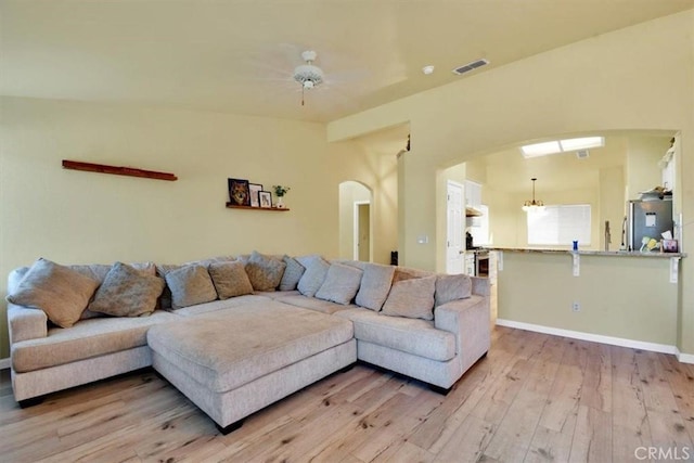 living room with ceiling fan and light hardwood / wood-style floors