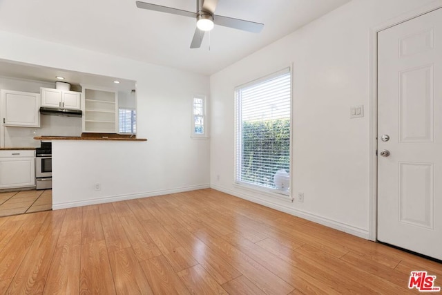 unfurnished living room featuring light hardwood / wood-style floors and ceiling fan