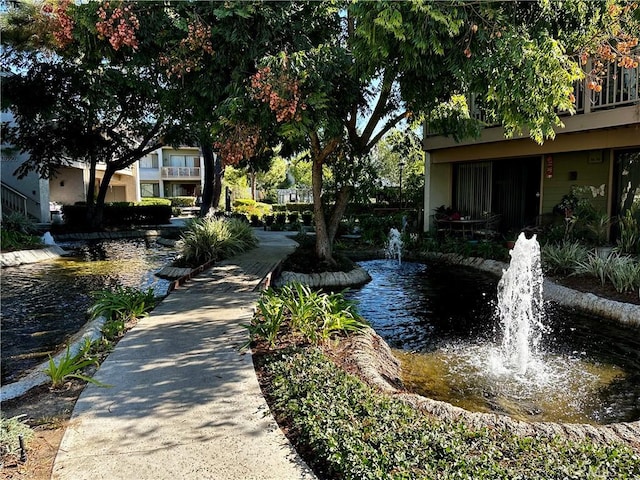 view of community with a garden pond