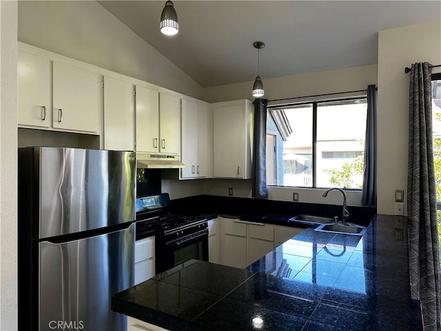 kitchen featuring gas stove, stainless steel fridge, pendant lighting, lofted ceiling, and white cabinets