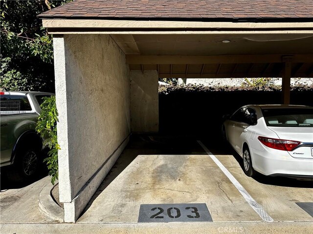 view of vehicle parking featuring a carport