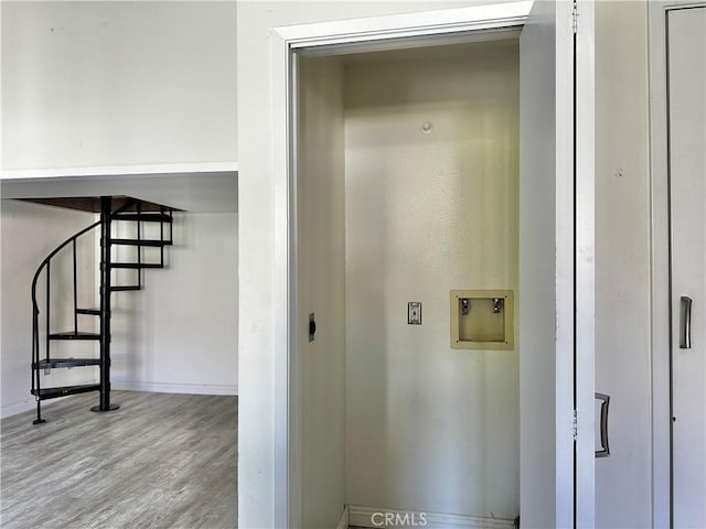 clothes washing area featuring light wood-type flooring