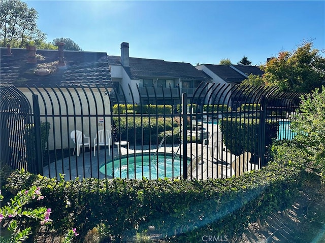 view of pool with a community hot tub