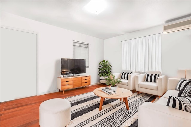 living room featuring plenty of natural light, hardwood / wood-style floors, and a wall mounted air conditioner