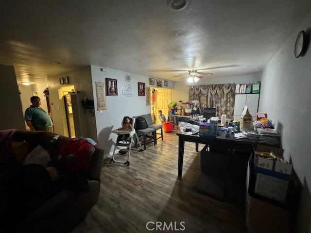 interior space with wood-type flooring and ceiling fan