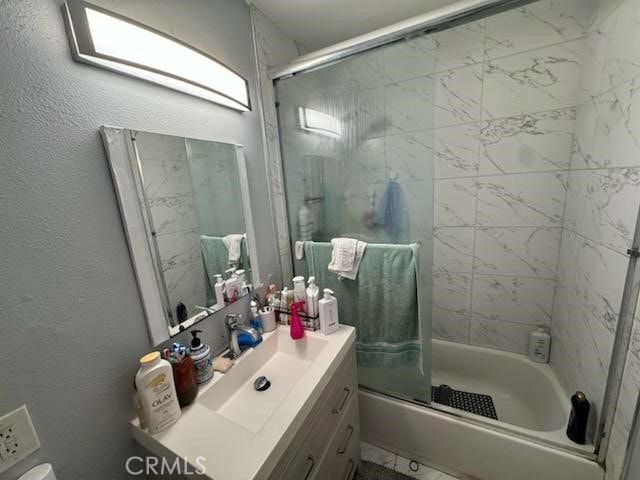 full bathroom featuring vanity, toilet, and enclosed tub / shower combo