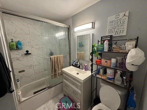 full bathroom with vanity, toilet, and bath / shower combo with glass door