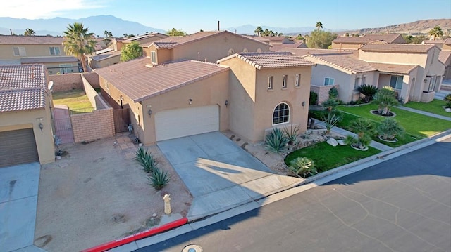 view of front facade with a mountain view and a garage