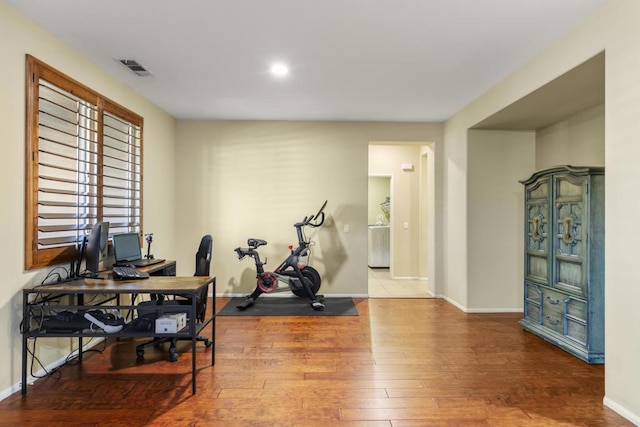 home office with hardwood / wood-style flooring