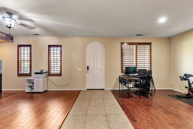 foyer with ceiling fan and light hardwood / wood-style flooring