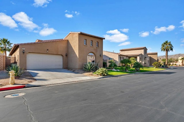 mediterranean / spanish-style house with a garage