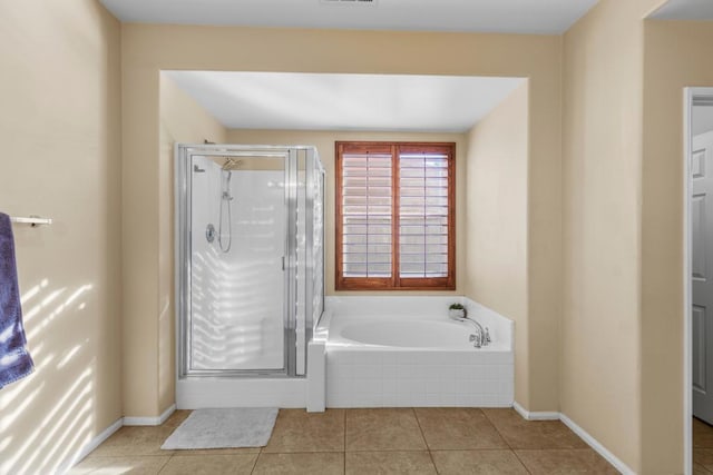 bathroom with tile patterned flooring and shower with separate bathtub