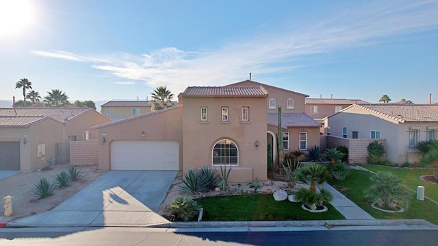 mediterranean / spanish-style house with a garage