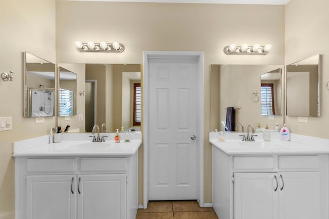 bathroom with vanity, tile patterned floors, and a healthy amount of sunlight