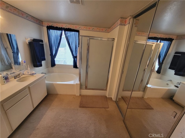 bathroom featuring vanity and separate shower and tub