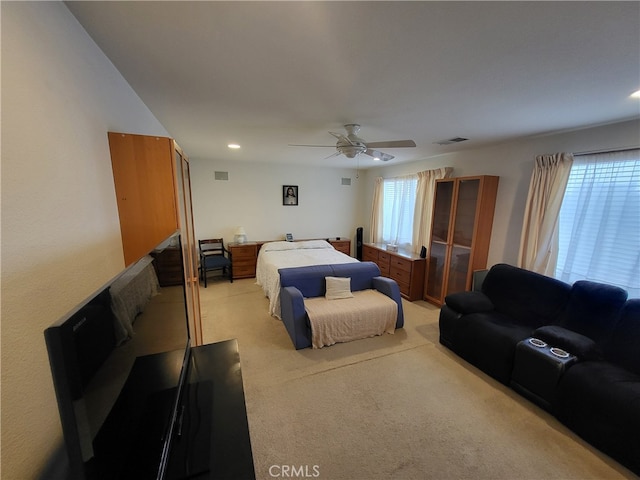 bedroom featuring light colored carpet and ceiling fan